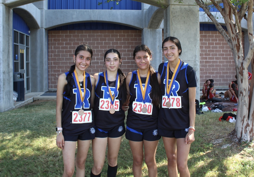 cross country runners with medals