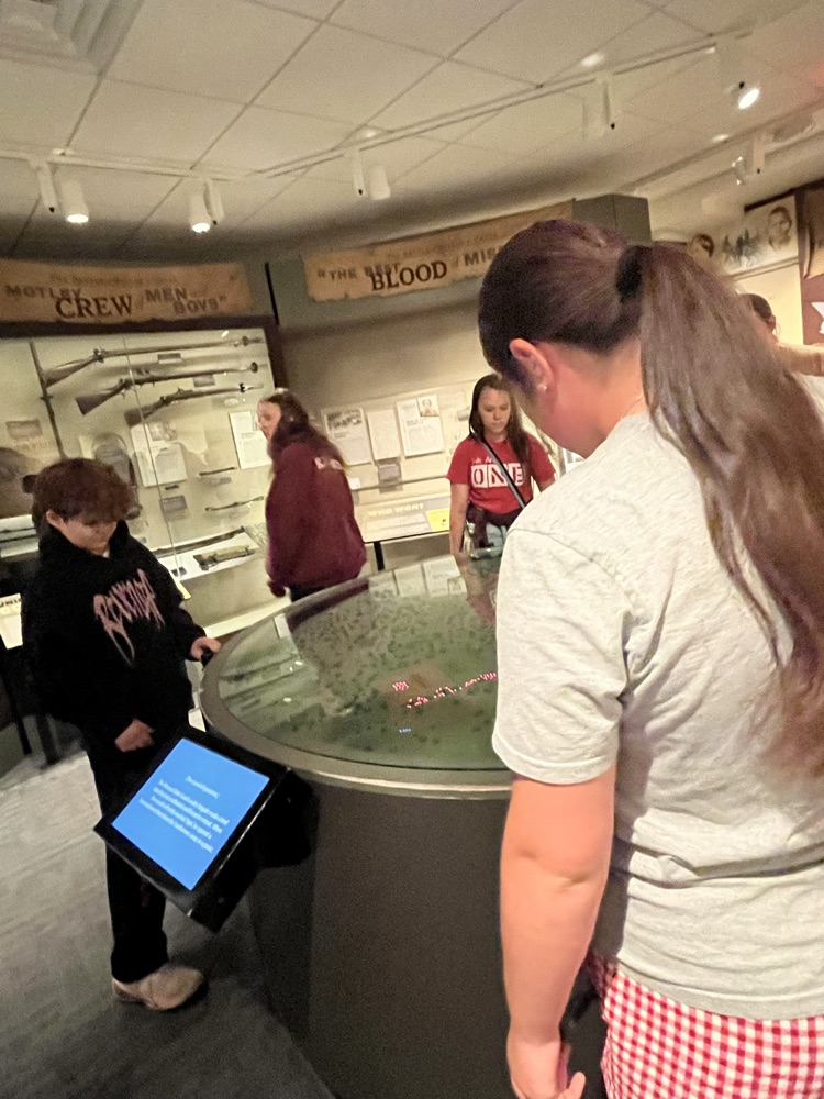 Another view of the students viewing the Battle Diorama map  