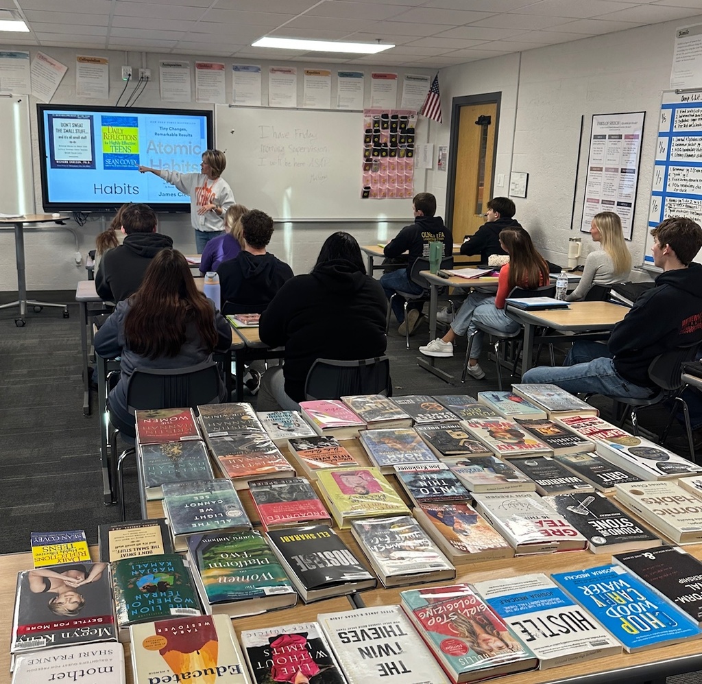 Mrs. Julian showing what the library has to offer