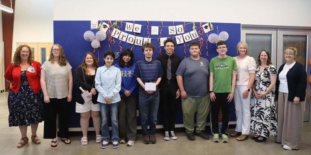 A group photo of the graduating seniors from Wisdom Ridge Academy alongside Superintendent Dr. Jenny Rodriquez, Principal Susan Smith, and school board members Amanda Ronstadt and Donna Farnsworth