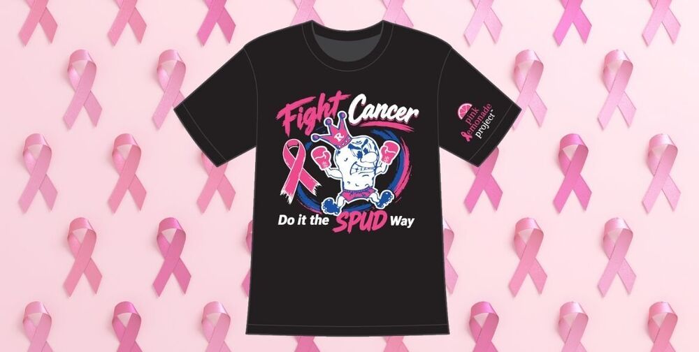 A black tshirt that says "Fight Cancer: Do it the Spud Way" with the Kind SPudder logo wearing pink boxing gloves. Behind the tshirt is a collage of pink ribbons
