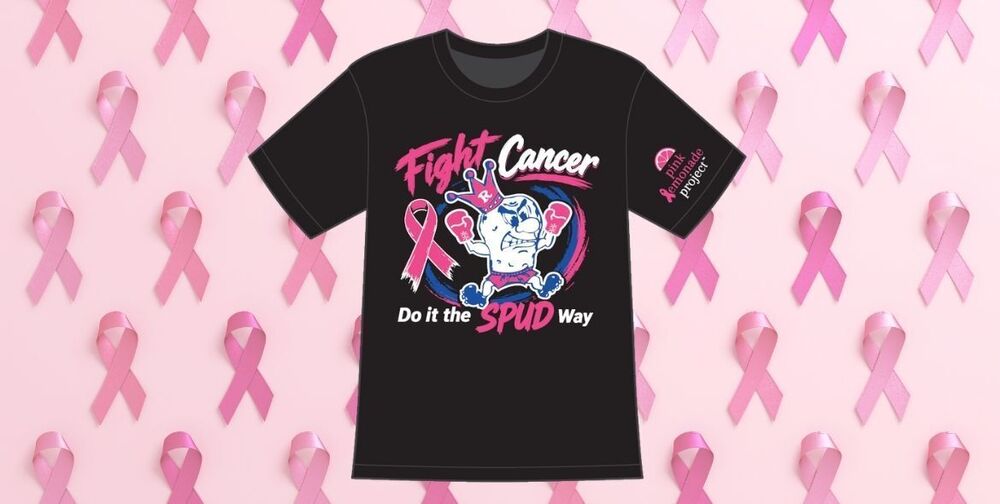 A black tshirt that says "Fight Cancer: Do it the Spud Way" with the Kind SPudder logo wearing pink boxing gloves. Behind the tshirt is a collage of pink ribbons