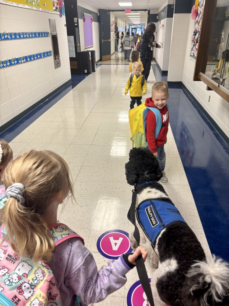 Marshall the dog in line with students