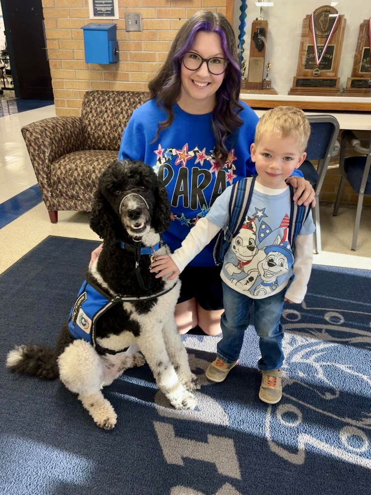 dog with students and staff matching colors