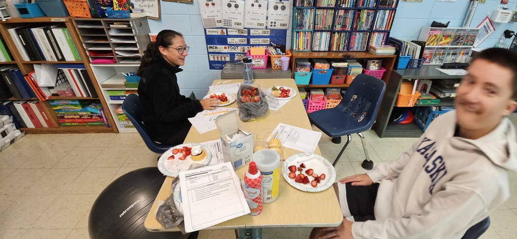 Students making strawberry shortcake.