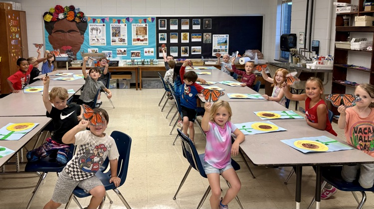 Butterflies flying in the art room.