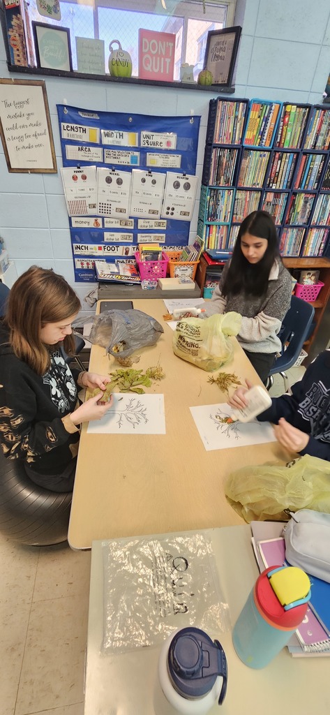 Students gluing leaves.