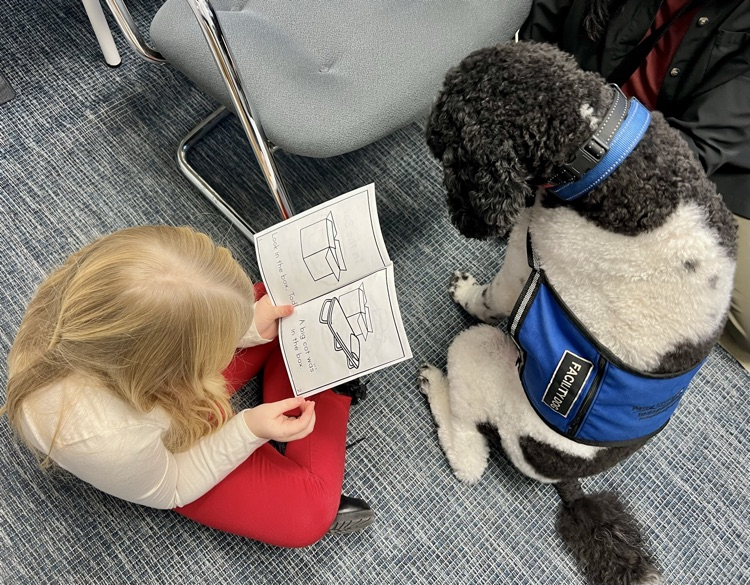 dog listening to student read