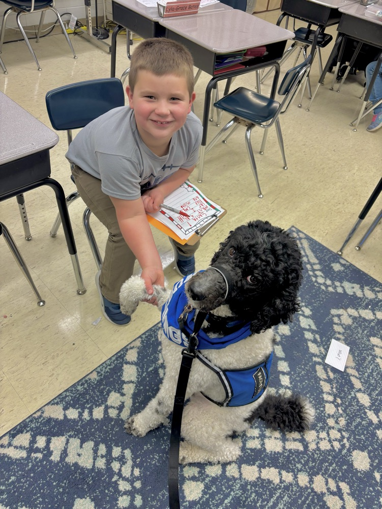 dog giving a shake to student 