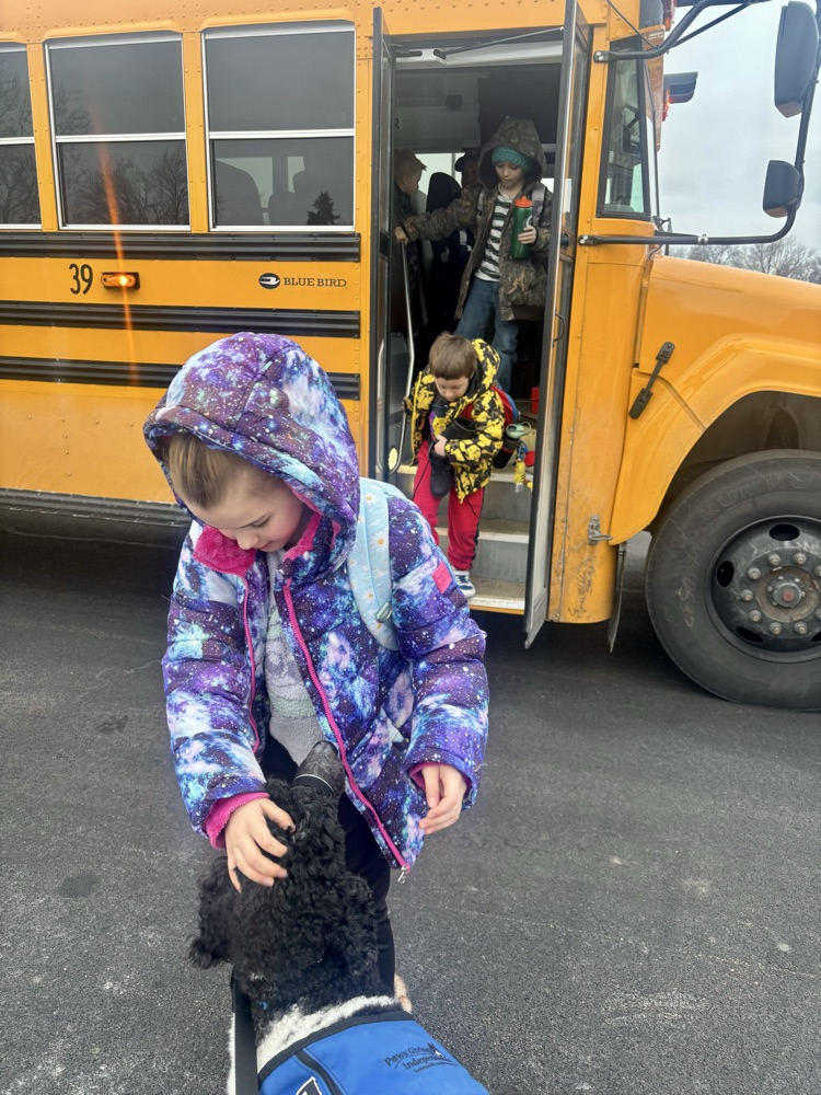 dog greeting kids getting off bus