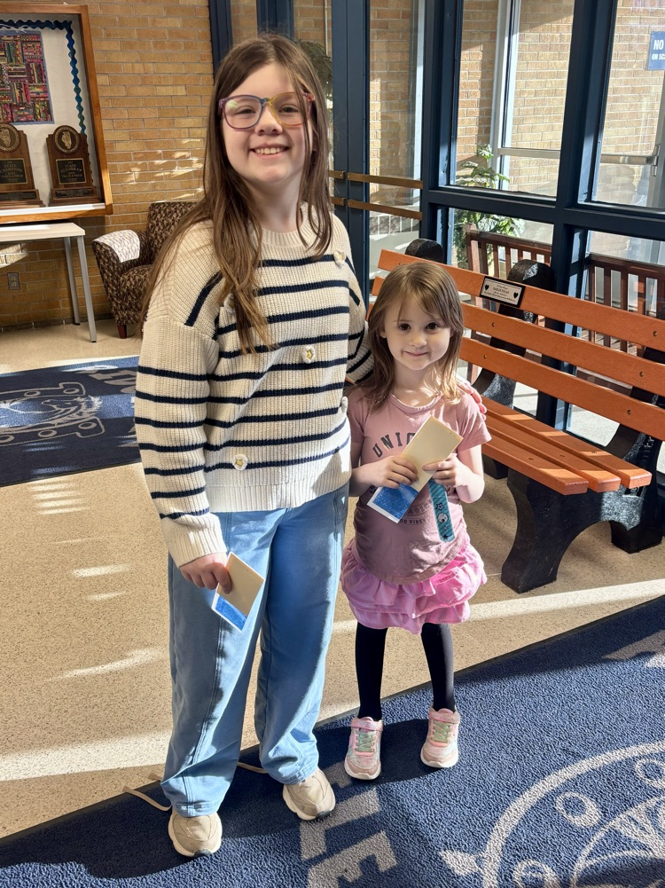 two girls holding prizes