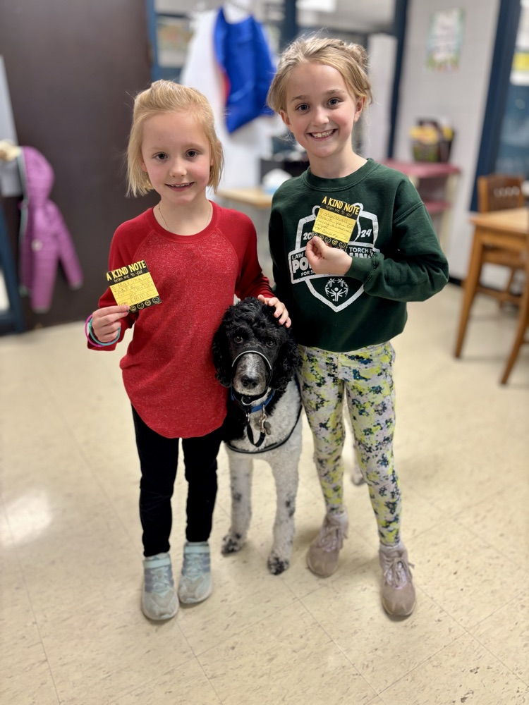 girls with kindness notes for the facility dog