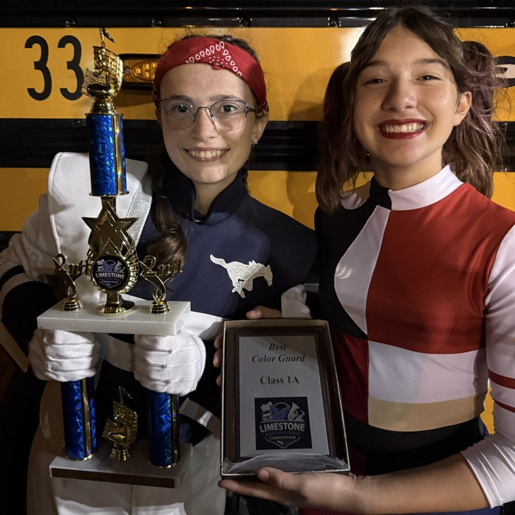 Drum Major Addi Scaggs and Guard member Isaria Veytia display Ridgeview’s awards from tonight’s contest at LCHS