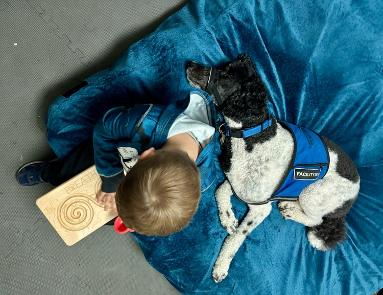 boy and dog snuggling 