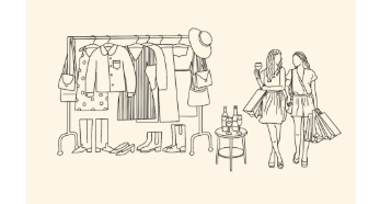 A rack of women's clothing and two ladies shopping