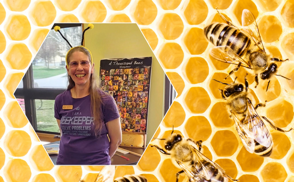 Dr. Terra Malmstrom smiling in a purple beekeeper shirt with bee antennae headband, set against a honeycomb background with bees.