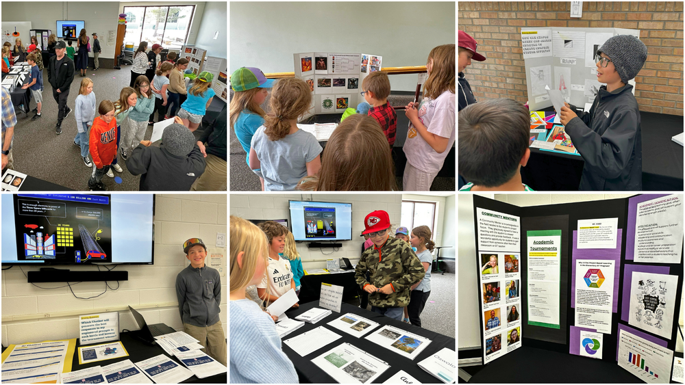 Elementary students presenting projects and displays at a school showcase while classmates and visitors explore exhibits.
