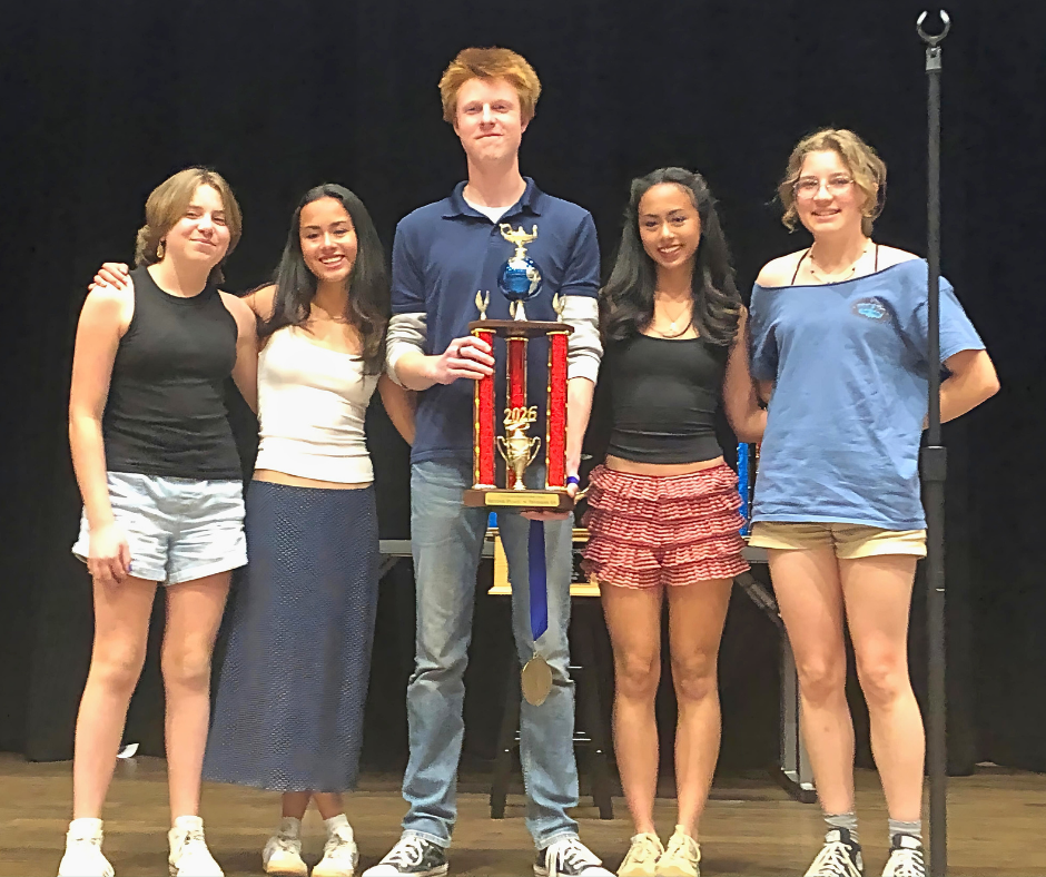 Five students stand on a stage holding a trophy, smiling after earning second place at a state Knowledge Bowl competition.