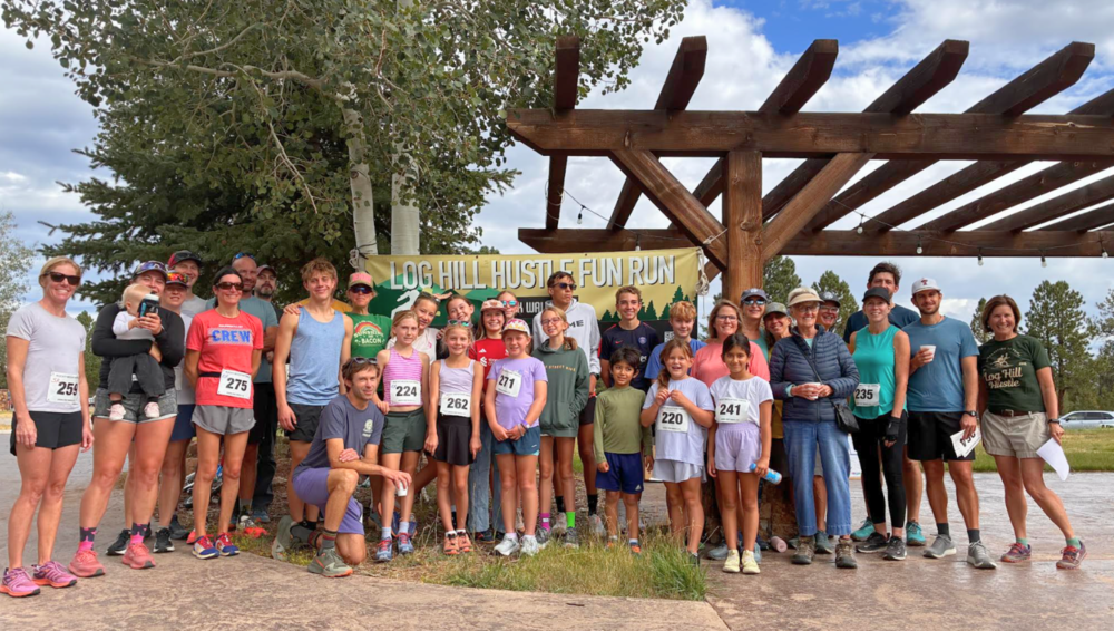 Group of students, staff, families, and community members gathered at the Log Hill Hustle Fun Run.