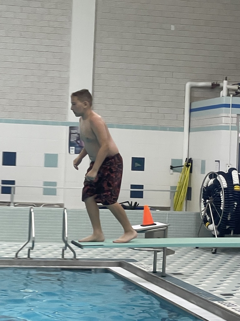 Student jumping off the diving board during Eagle U Swim