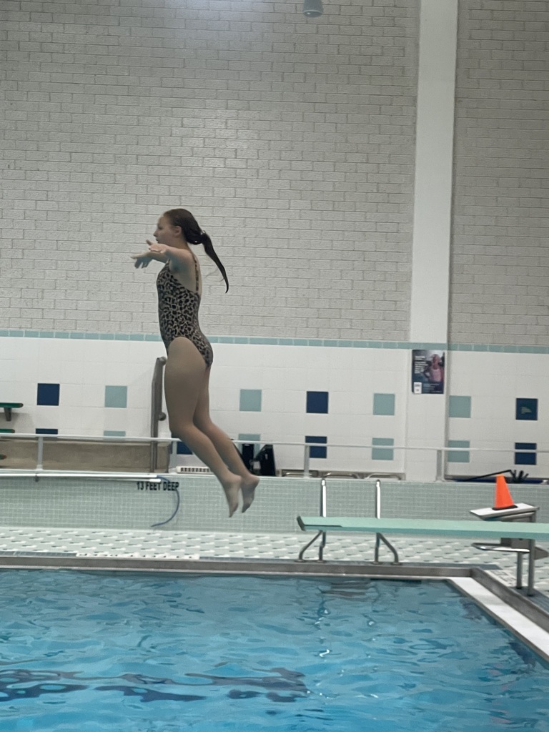 Student jumping off the diving board during Eagle U Swim