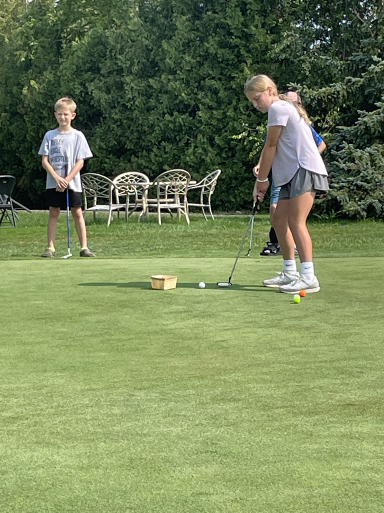 Girl putting golf 