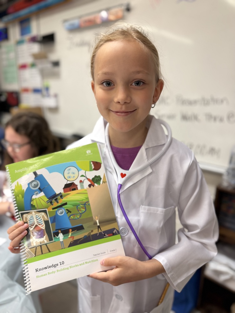 student holding the text book