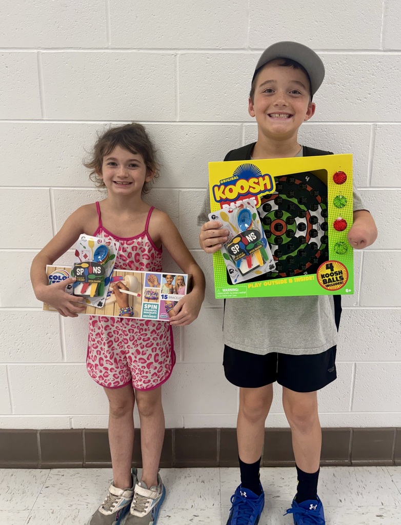2 students - Lillie and Cooper with their attendance basket prizes