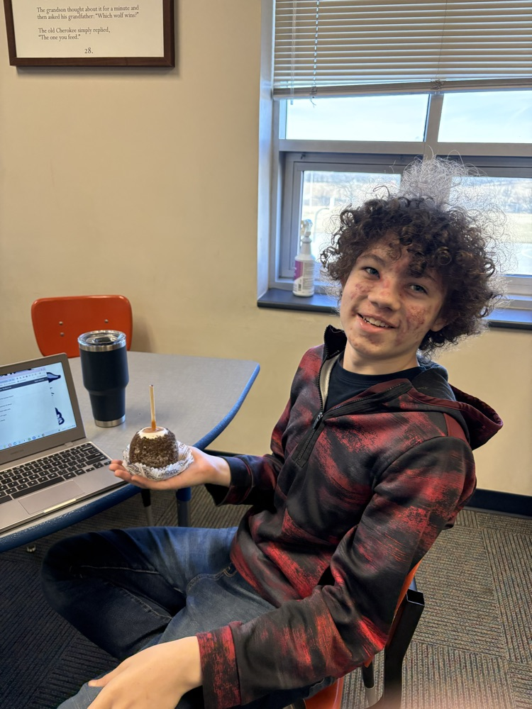 7th grader holding an 🍎 .