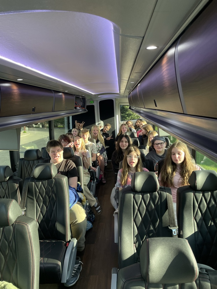 8th graders sitting on bus 