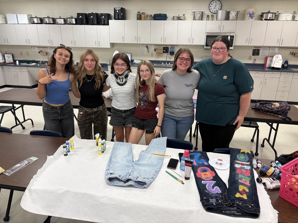 Students from the class of 2027 paint jeans before the first day of school