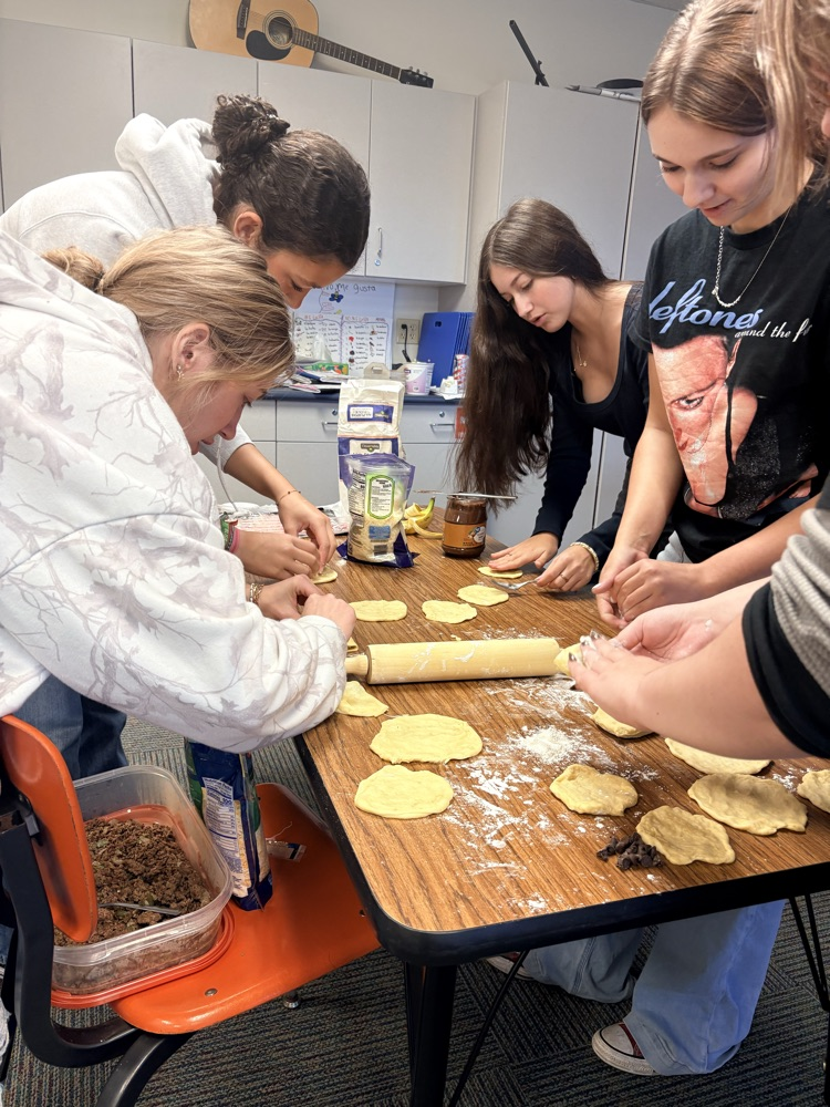 students rolling out dough
