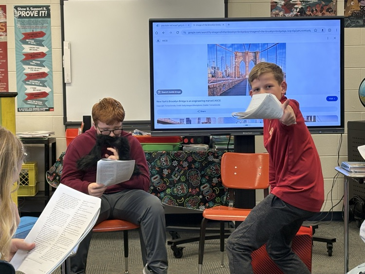 sixth grade students reading “The Hitchhiker”.