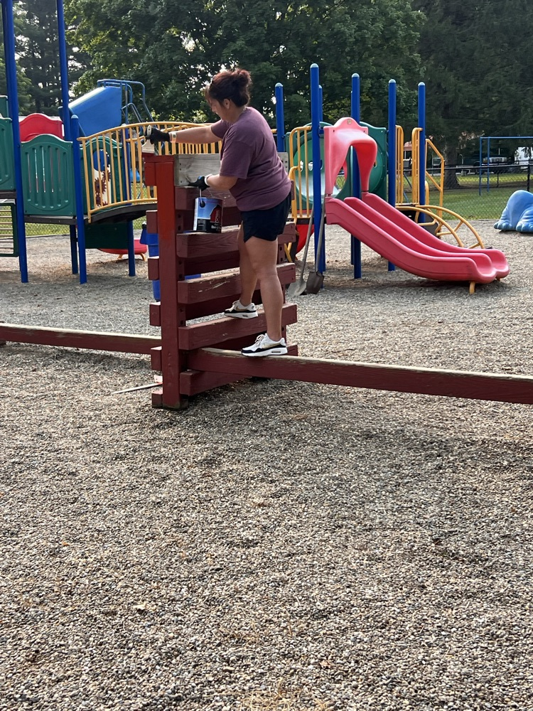 Volunteers painting the playground 