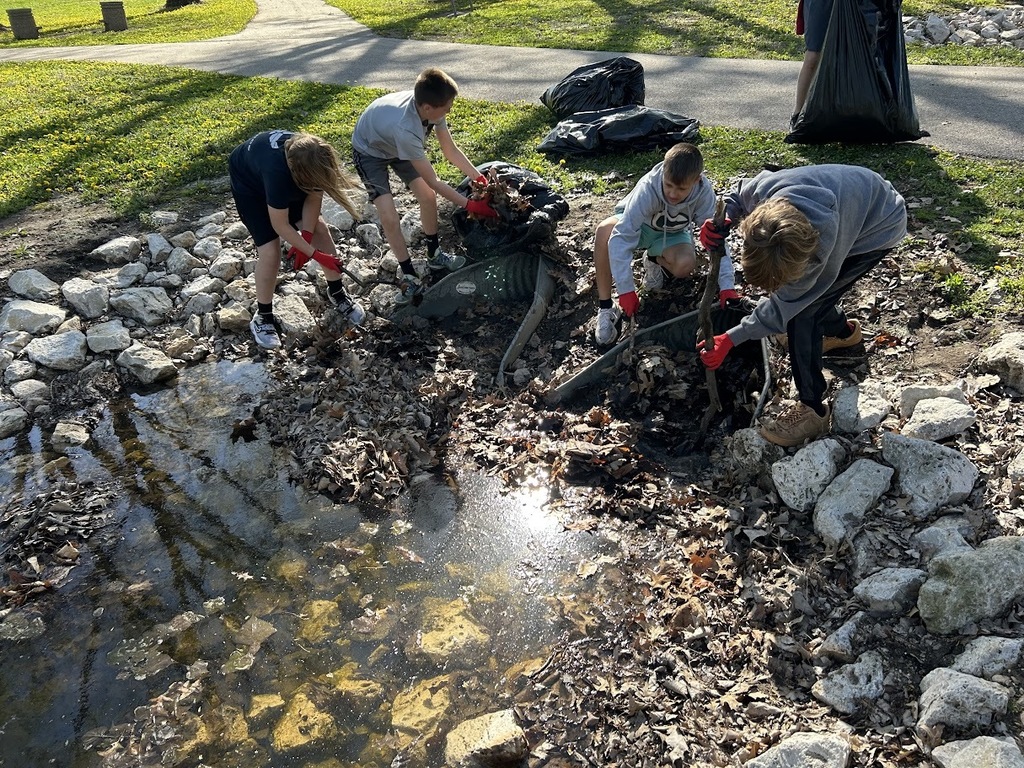 students cleaning out storm drains