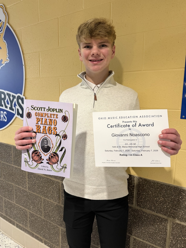 gio holding his award and performance piece.