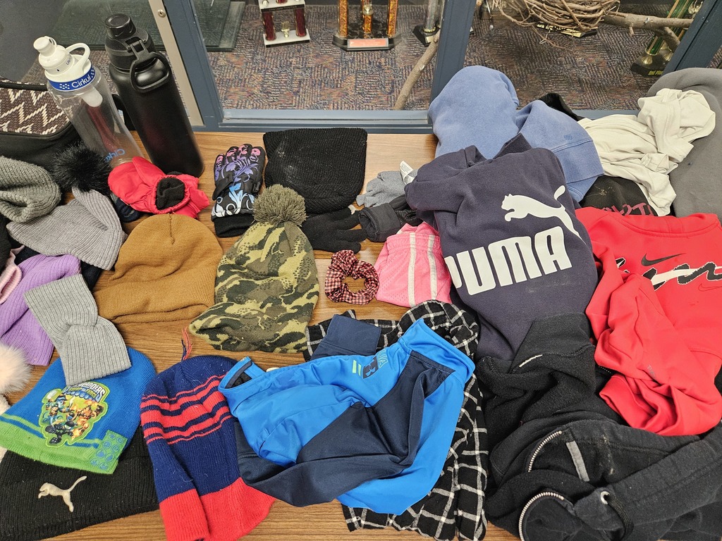 Shirts and winter hats on the table.