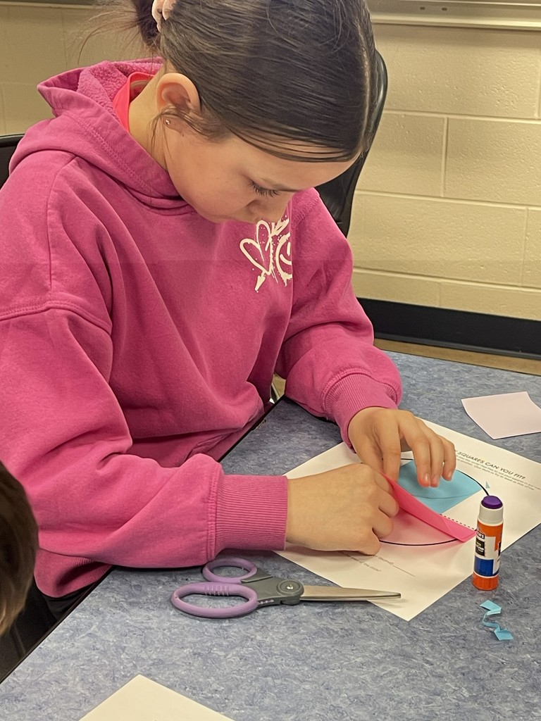 Student gluing post its to discover area of circles