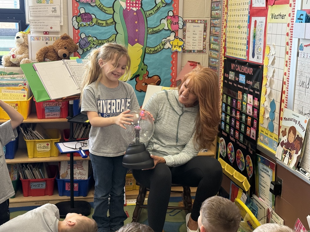 Teacher showing a girl how to use the static ball