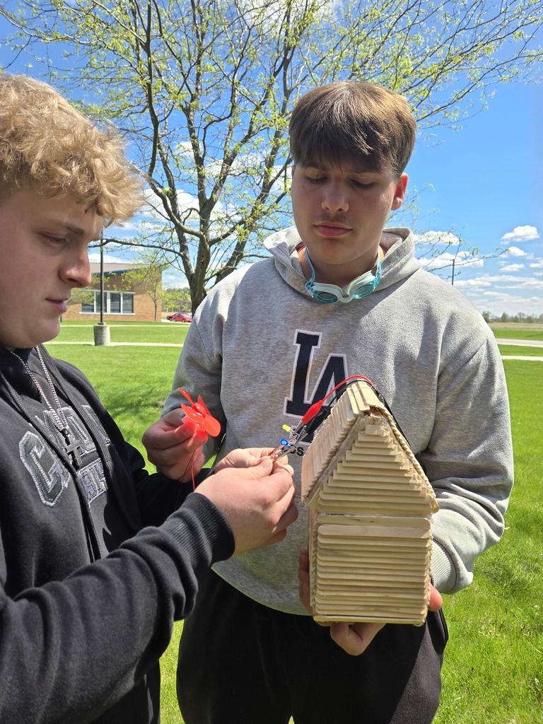 Students making sure wires are connected correctly to turn the lights on. 