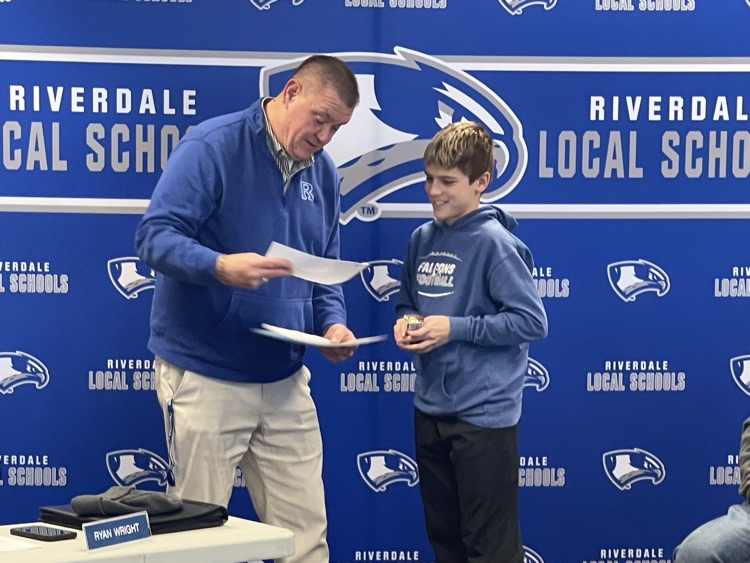 Mr. Maag giving a student of the month award. National Principals Day. 