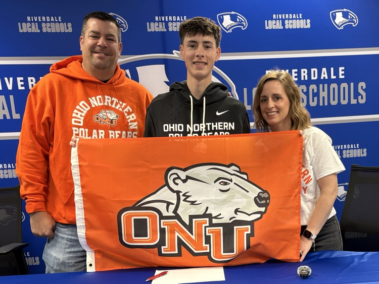 Nathan and parents holding ONU flag