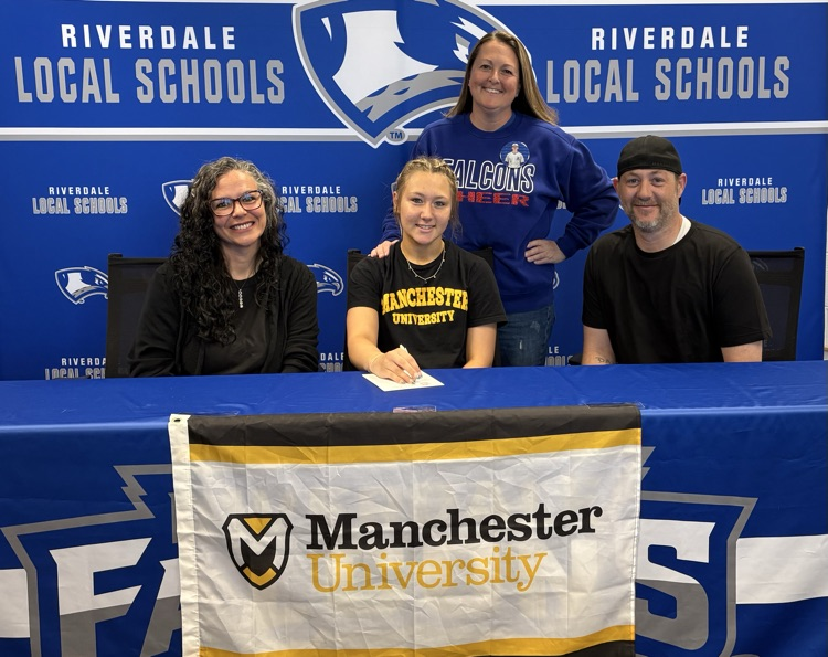 Lillian signing with parents and coach Phelps 