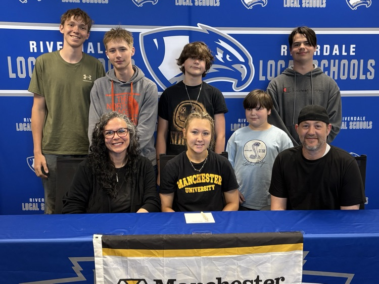 Lillian signing with parents and siblings 
