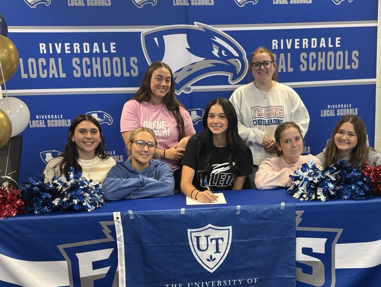 Kasey signing with other cheerleaders 