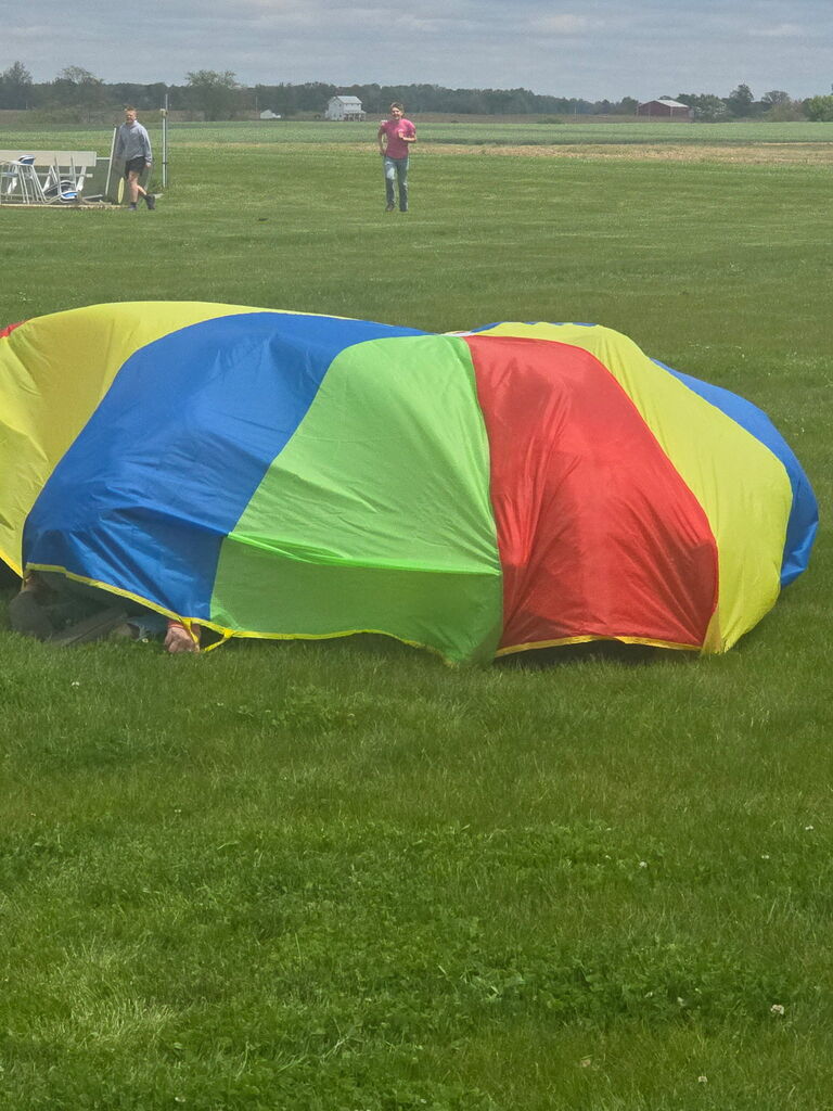 hiding under the parachute