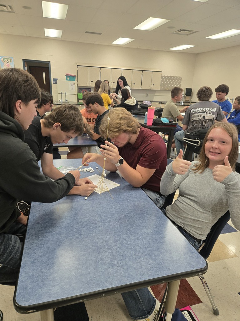 several student groups working on their spaghetti towers