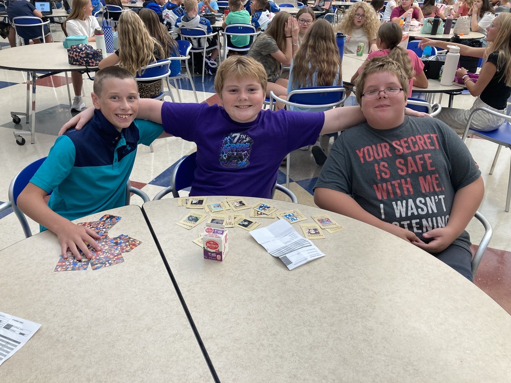 Image includes students during their lunch period smiling bit for the First day of school