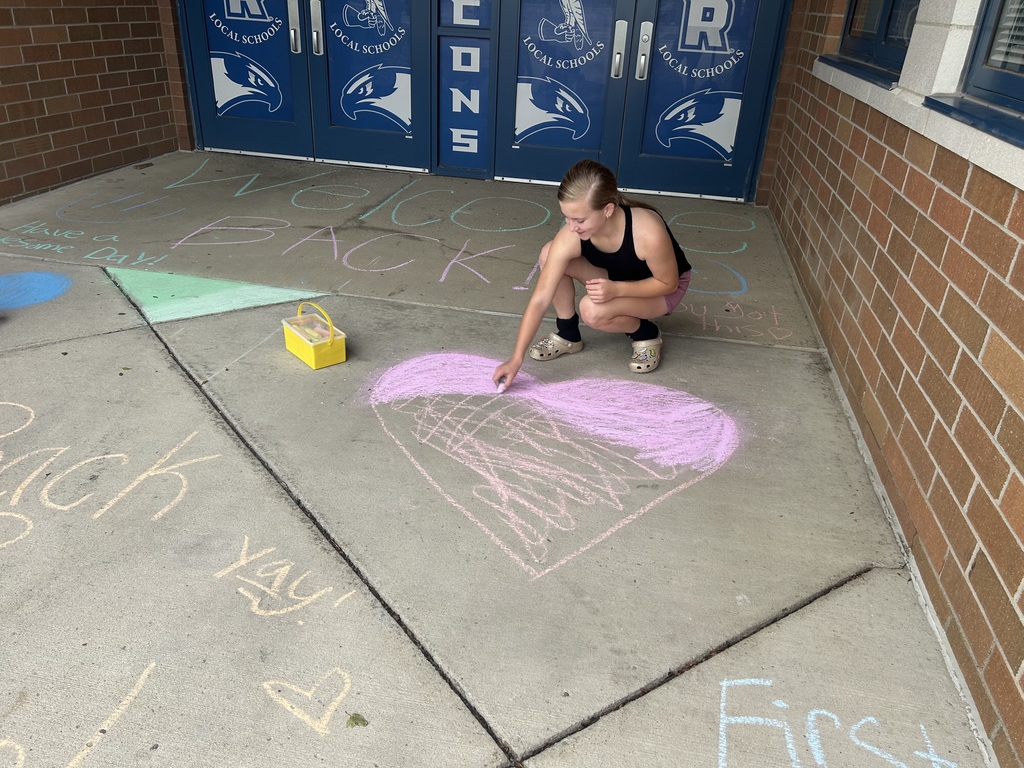 Riverdale Girls Highschool Soccer Team create chalk drawings at the student entrances to bring in the new school year with pride and fun.