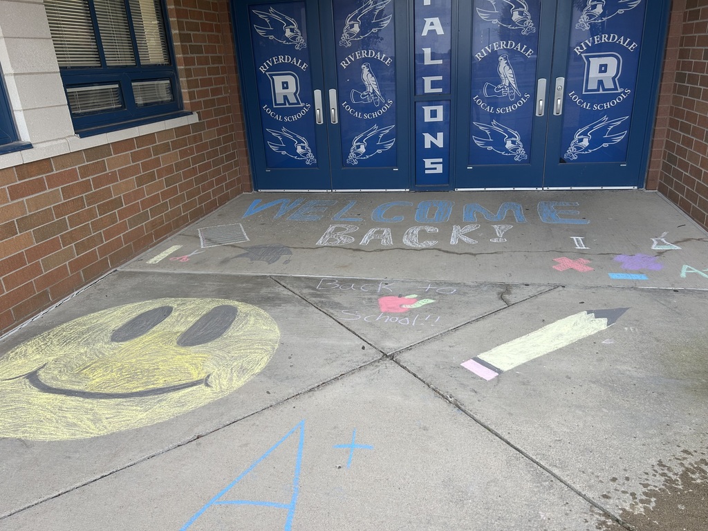 Riverdale Girls Highschool Soccer Team create chalk drawings at the student entrances to bring in the new school year with pride and fun.